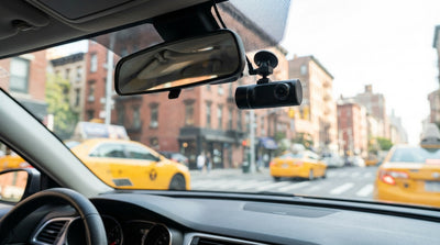 View from a car hire dashboard with a dash cam recording traffic on a busy New York City street