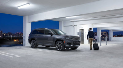 A car rental vehicle parked in a lot with a view of the New York City skyline at sunset