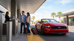 A line of travelers with luggage at a busy Las Vegas car rental counter