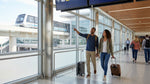 Passengers with luggage walking inside Terminal C at Orlando Airport toward the car hire facilities
