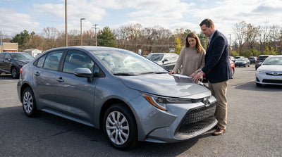 A modern car rental on a scenic drive through the rolling hills and autumn foliage of rural Pennsylvania