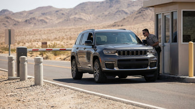 A car rental driving on a scenic desert highway outside Las Vegas with mountains on the horizon