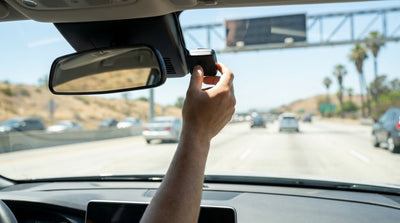 A modern car hire driving across the Golden Gate Bridge on a sunny day in California