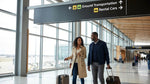 A traveler with luggage follows overhead signs for car rental at the Pittsburgh Airport terminal in Pennsylvania