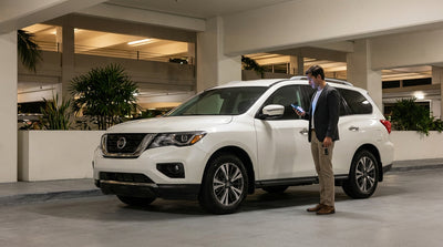 A modern car hire parked in a well-lit rental return bay at the Miami airport at night