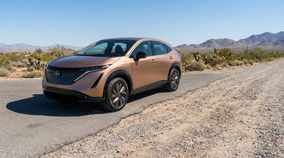 A modern car rental SUV on a dirt road in the red rock canyons near Las Vegas