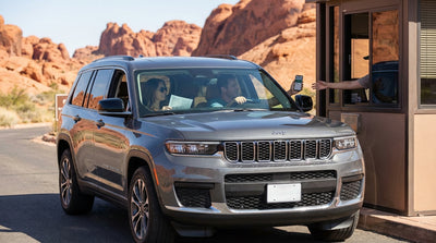 A car hire drives the scenic loop road through Red Rock Canyon's vibrant sandstone landscape just outside Las Vegas