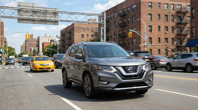 A car hire driving in heavy traffic with yellow cabs on a busy street in New York City