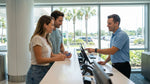 A customer discusses upgrade options for their car hire with an agent at a desk in Orlando