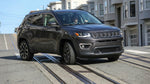 A car hire drives across the cable car tracks on a steep, sunny street in San Francisco