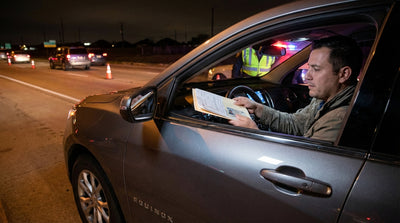 Driver's view of a Texas sobriety checkpoint at night from inside their car rental