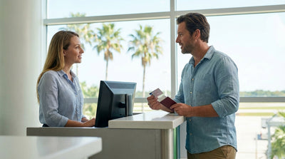 A red convertible car hire driving on a sunny coastal highway lined with palm trees in Florida