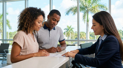 A white convertible car hire driving down a sunny, palm-lined coastal road in Florida