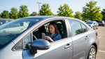A driver navigating with a phone map in a car rental on a scenic highway in Pennsylvania