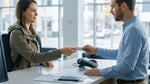 Person handing a credit card to an agent at a car hire counter in Pennsylvania