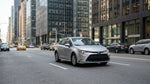 Driver inside a car rental navigating heavy traffic on a Manhattan street in New York