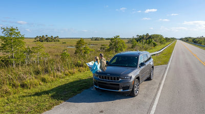 A car hire driving on Alligator Alley, a straight highway cutting through the Florida Everglades wetlands