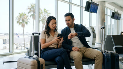 A line of cars at a car rental center with the LAX control tower in the background in Los Angeles