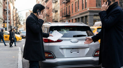 A car hire vehicle parked on a New York street with its license plate missing