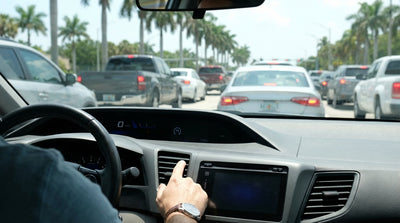 A driver's view from a car hire of heavy traffic on a palm-lined highway in Florida