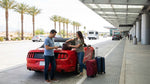 The brightly lit car rental center at the Las Vegas airport with signs for various companies