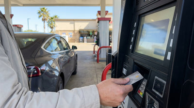 A driver uses a credit card at a gas pump in Texas to refuel their car rental