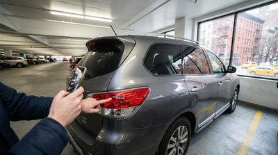 Close-up of a long, deep scratch on the door of a car hire parked in a concrete New York garage