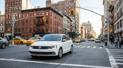 View from a car rental stopped at a red light at a busy New York City intersection