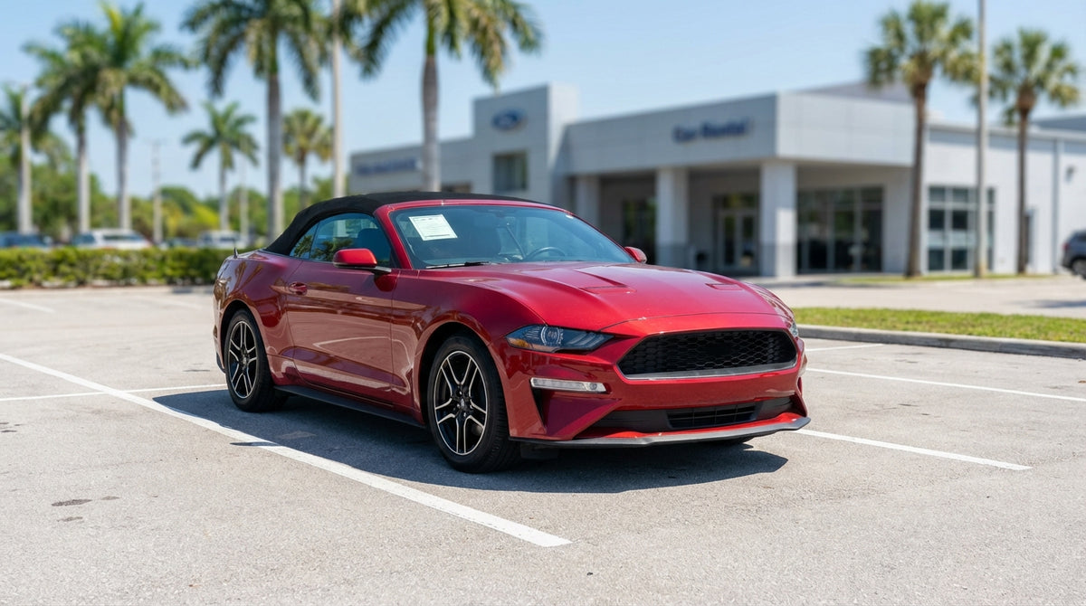 A red convertible car hire drives along a scenic, sun-drenched coastal highway in Florida