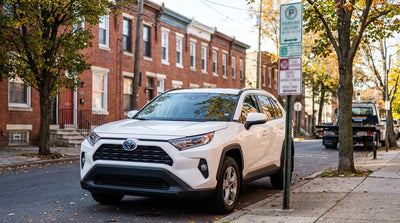 A driver with a car hire studies a permit parking sign on a residential street in Philadelphia, Pennsylvania