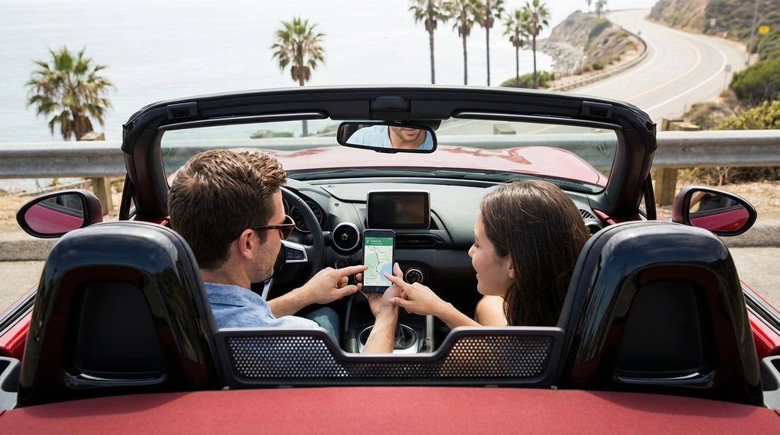 A person uses a smartphone for navigation in their car hire on a sunny highway in California