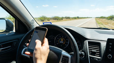 The TPMS warning light glowing on the dashboard of a car hire vehicle on a road in Texas