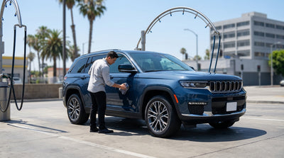 A modern car hire driving down a sunny, palm-lined street in Los Angeles