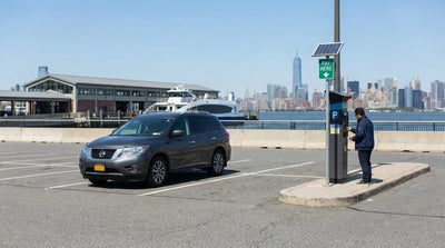The iconic orange Staten Island Ferry crosses New York Harbor, a popular trip for those exploring the city with a car hire