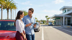 Person placing a credit card on a car rental counter next to car keys in Orlando