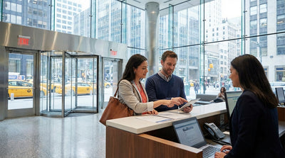 Yellow cabs and a car hire vehicle on a bustling street in midtown Manhattan surrounded by tall skyscrapers