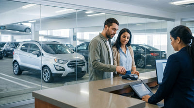 A person paying for their New York car hire with a credit card at a rental counter terminal