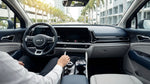 Driver steering an automatic car rental along a sunny palm-lined coastal road in Miami
