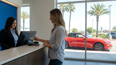 A red convertible car hire driving along the sunny Pacific Coast Highway in California