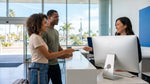 Person receiving keys across a service counter for a car rental in California