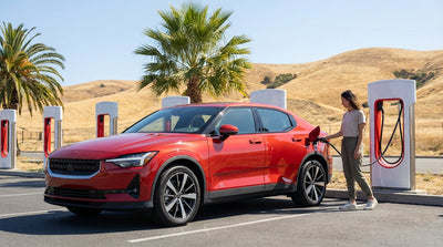 A modern electric car rental charging at a Tesla Supercharger station under palm trees in California