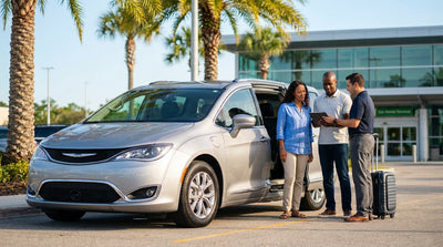 A family loads their luggage into a spacious minivan car rental parked on a sunny street in Orlando