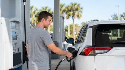 Driver filling up a car rental with gas at a sunny petrol station in Florida