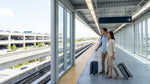 Passengers with luggage walking from the Metrorail station to a Miami airport car rental desk