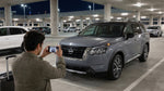 A modern car in a dimly lit car rental return garage at the Las Vegas airport at night
