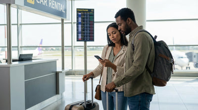 A traveler checks their watch at a car hire counter in New York's JFK airport