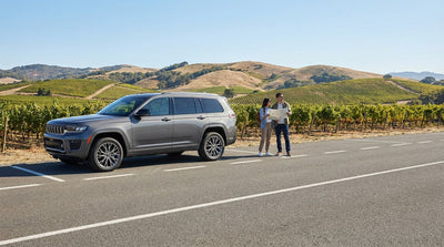 A red convertible car hire at a scenic overlook with the Golden Gate Bridge in San Francisco
