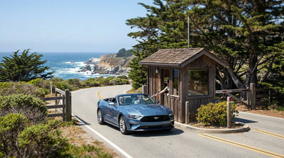 A car hire driving the scenic coastal road of 17-Mile Drive in California with ocean views