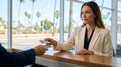 A stylish convertible car hire parked under palm trees on a sunny street in Los Angeles