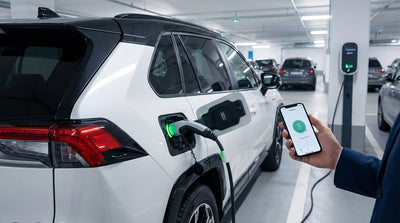 A modern plug-in hybrid car rental charging at a station with palm trees in sunny California